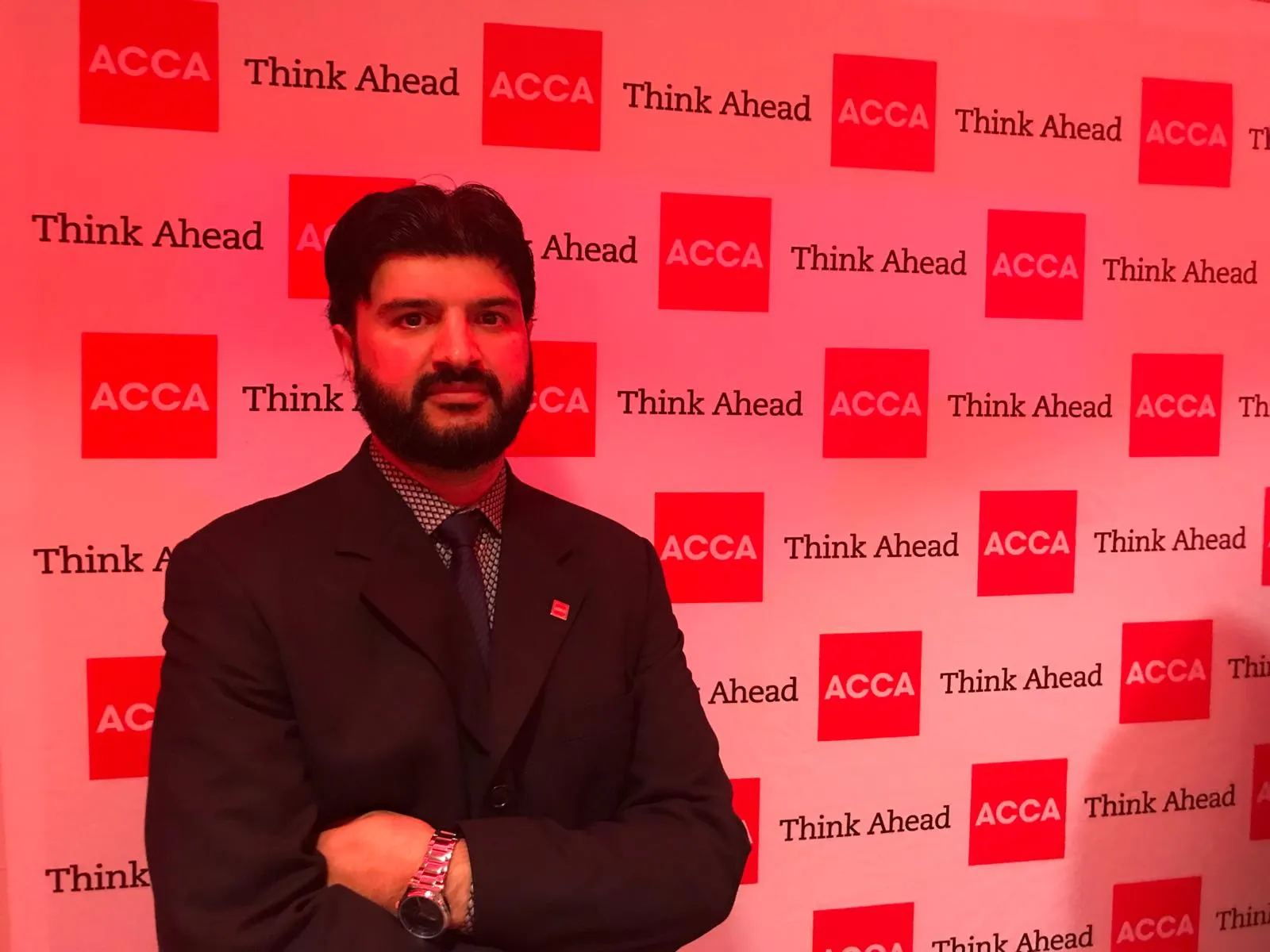 Ejaz Afridi standing in front of an ACCA ‘Think Ahead’ event backdrop